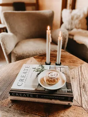 a table with a plate of doughnut and candles on top at Mountain Chalet Pra Ronch in Selva di Val Gardena