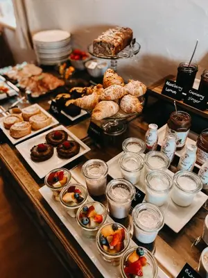 a buffet of pastries and other pastries on a table at Mountain Chalet Pra Ronch in Selva di Val Gardena
