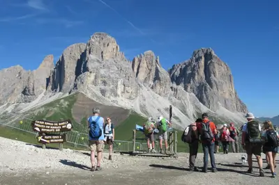 a group of people standing in front of mountains at Sella Ronda Apartment in Campitello di Fassa