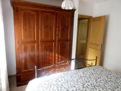 a bedroom with a bed with a black frame and a mirror at Gal28 in Predazzo