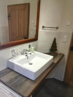 a bathroom with a white sink and a mirror at Ferienhaus/Chalet in der Blaiche in San Leonardo in Passiria
