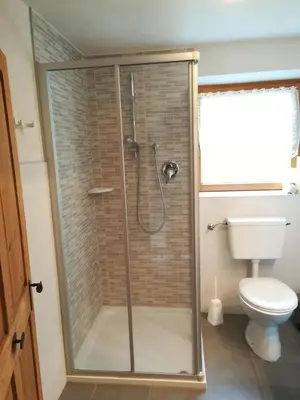 a bathroom with a shower and a toilet at Ferienhaus/Chalet in der Blaiche in San Leonardo in Passiria