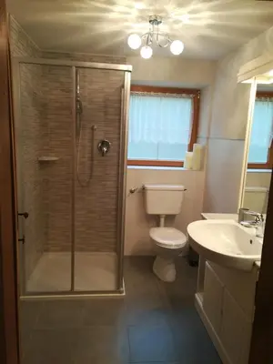 a bathroom with a shower and a toilet and a sink at Ferienhaus/Chalet in der Blaiche in San Leonardo in Passiria