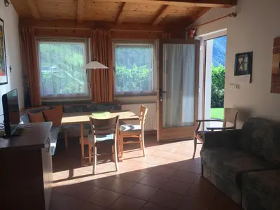a living room with a table and a couch at Weingut Zundlhof in Bolzano