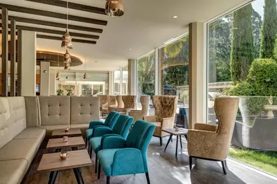 a living room with a couch and chairs at Hotel Anatol in Merano