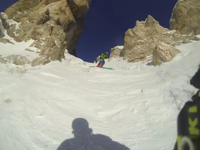 two people skiing down a snow covered mountain at Telemark Mountain Rooms in Agordo