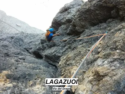 a man is climbing on a rocky mountain at Telemark Mountain Rooms in Agordo