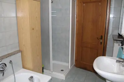 a bathroom with a shower and a sink and a toilet at Appartamento Widmann in Coredo