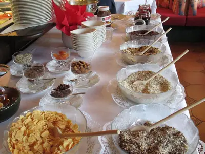 a table filled with different types of food at Hotel Schönbrunn in Merano