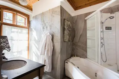 a bathroom with a tub and a sink and a bath tub at Schlosswirt Forst in Lagundo