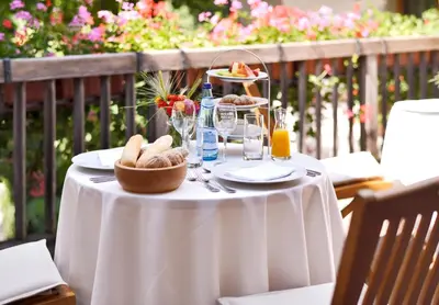 a table with a white table cloth with food on it at Schlosswirt Forst in Lagundo