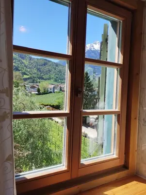 a window with a view of a mountain at Schlosswirt Forst in Lagundo