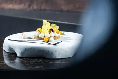 a table with a plate with food on it at Linder Cycling Hotel in Selva di Val Gardena