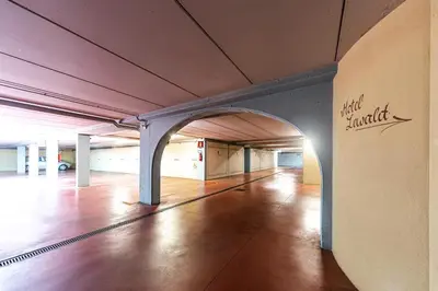 an empty hallway in a building with a wooden floor at Hotel Ristorante Lewald in Bolzano