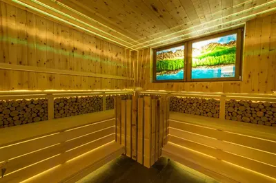 a sauna with wooden walls and two televisions at Hotel Ristorante Lewald in Bolzano