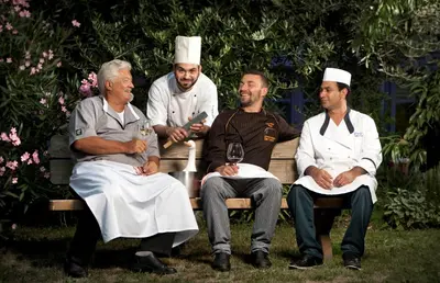 a group of three men sitting on a bench at Hotel Ristorante Lewald in Bolzano
