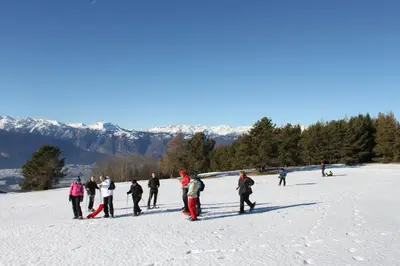 a group of people are standing in the snow at Rifugio Sores Adventure in Coredo