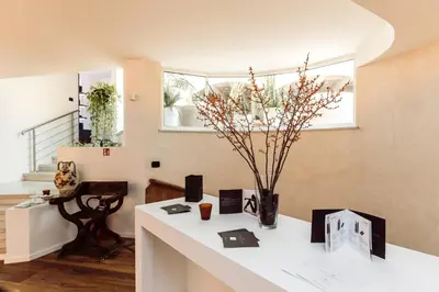 a room with a white counter with a vase of flowers at Hotel Castel Rundegg (Adults Only) in Merano