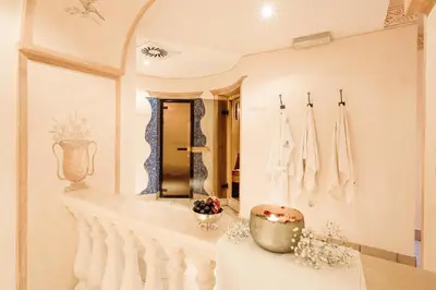 a dressing room with a mirror and a table at Hotel Castel Rundegg (Adults Only) in Merano