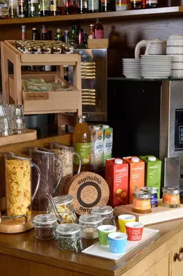 a counter with different types of food on it at Hotel Garni Roberta in Malga Ciapela
