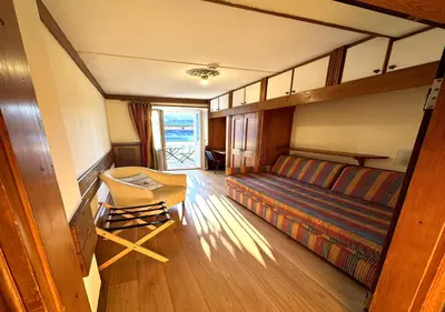 a room with a bed and a table in a room at Parc Hotel Victoria in Cortina dʼAmpezzo
