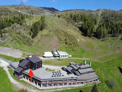 an aerial view of a large building on a hill at Casa Cucciolo Falcade in Falcade