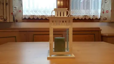 a wooden chair sitting on top of a table at Casa Cucciolo Falcade in Falcade