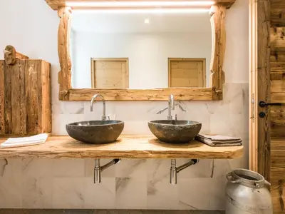 two sinks on a wooden counter in a bathroom at Ahner Berghof in Rodengo