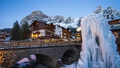 a group of flowers in front of a building at Hotel Cima Rosetta - BW Signature Collection in San Martino di Castrozza