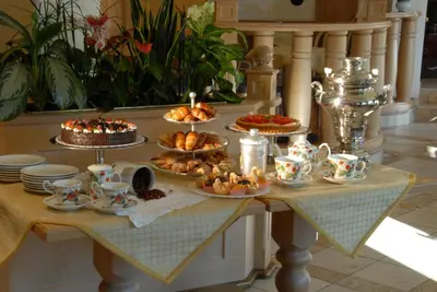 a table full of food on a table with desserts at Hotel Alle Alpi in Moena