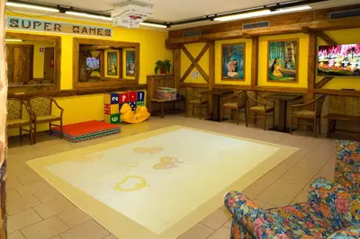 a waiting room with a carpet with a snake on it at Hotel Dolomiti Schloss in Canazei