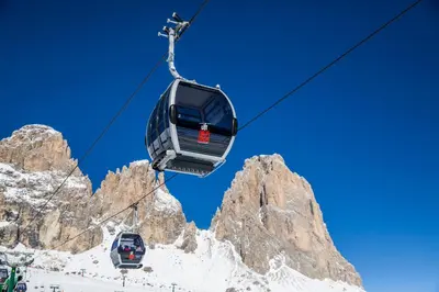 a ski lift in front of a mountain at Hotel Dolomiti Schloss in Canazei