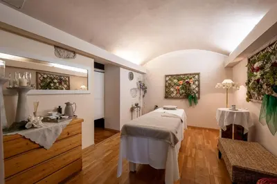 a room with a table and flowers on the wall at Hotel il Caminetto Sport in Canazei