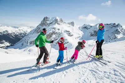 a group of people on skis on a snow covered mountain at Hotel il Caminetto Sport in Canazei