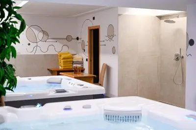 a bathroom with a bath tub and a shower at Hotel Bellevue in Canazei