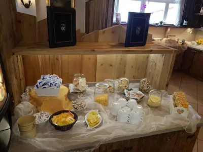 a table with food and other food items on it at Hotel Bellevue in Canazei