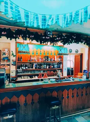 a bar in a restaurant with a counter top at IHR Hotel Villa Emma in Canazei