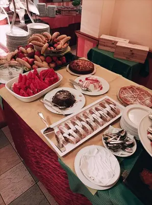 a table filled with different types of food at IHR Hotel Villa Emma in Canazei