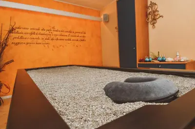 a room with a gray ottoman sitting on a table at Hotel Soreghes Gran Chalet in Campitello di Fassa