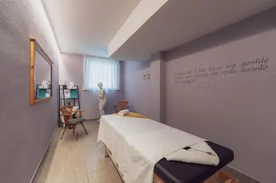 a bedroom with a bed and a table and a chair at Hotel Diamant Park in Campitello di Fassa