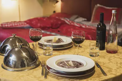 a restaurant with a counter in a room at Hotel Rubino Deluxe in Campitello di Fassa