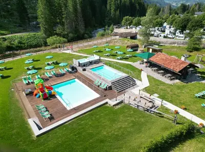 an aerial view of a resort with a swimming pool at Hotel Grohmann in Campitello di Fassa