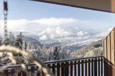 a balcony with a view of a snow covered mountain at Hotel Baumwirt in Castelrotto