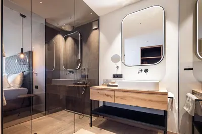 a bathroom with a sink and a mirror at Hotel Baumwirt in Castelrotto