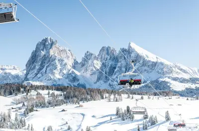 a ski lift in front of a snow covered mountain at Hotel Baumwirt in Castelrotto