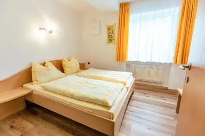 a bedroom with a large bed in a room at Haus Angelika in Nova Levante