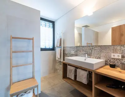 a bathroom with a sink and a mirror at naturApart in Brunico
