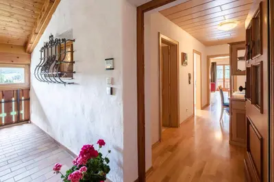 a hallway of a house with flowers on the floor at Am Rainell Hof in Ortisei