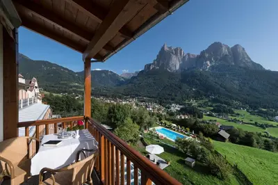 a balcony with a view of the mountains at Mirabell Alpine Garden Resort & Spa in Siusi