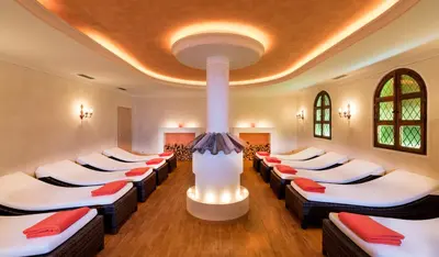 a room with a bunch of beds in it at Mirabell Alpine Garden Resort & Spa in Siusi